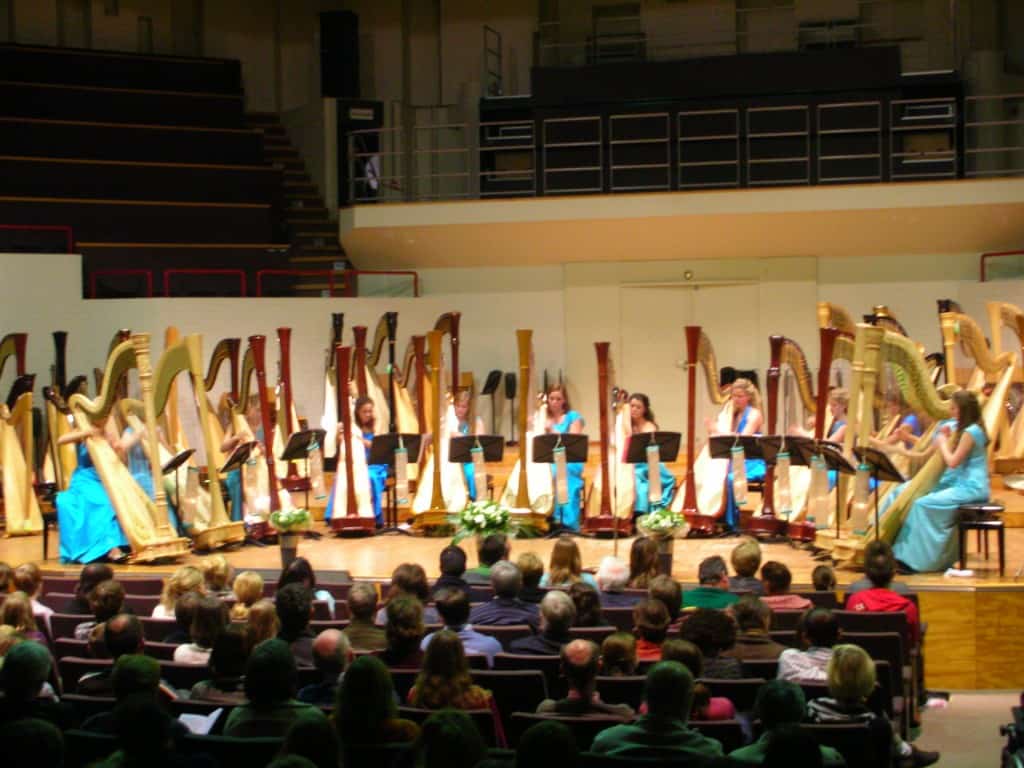 Megan Kartchner plays the harp in Belgium